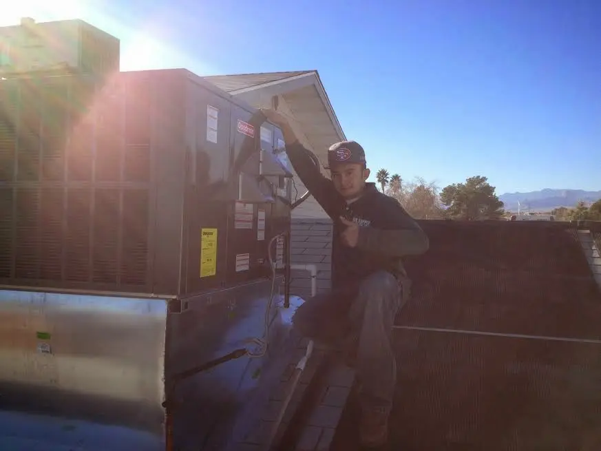 HVAC technician performing Boiler Repair on a rooftop unit in Cramerton